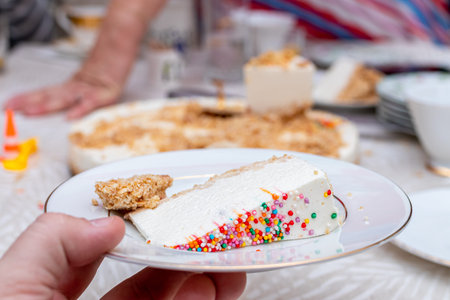 A piece of birthday cake on white table background.の写真素材
