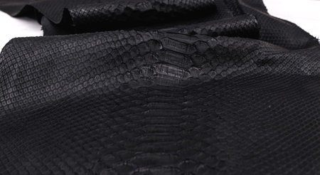 Real black snakeskin python leather. Snakeskin background.