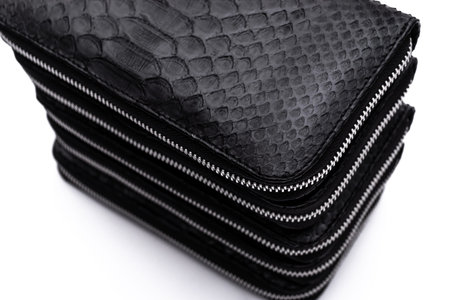 Fashion luxury snakeskin python black wallets isolated on a white background.