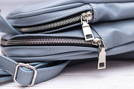 Synthetic leather backpack on a wooden background.の写真素材