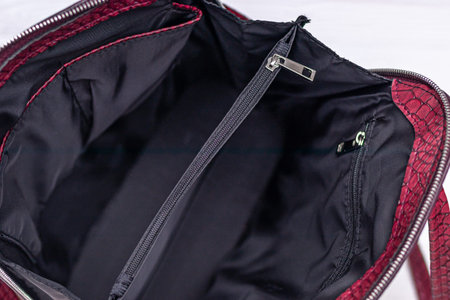 Synthetic leather backpack on a wooden background.