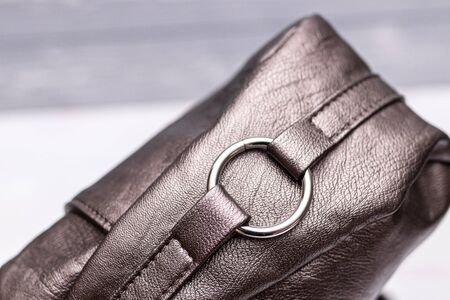 Fashion synthetic leather handbag on a wooden background.の写真素材