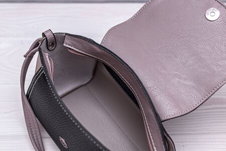 Fashion synthetic leather handbag on a wooden background.の写真素材
