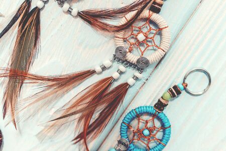 Ethnic dreamcatchers on a wooden background. Dream catchers, indian amulet, feathers, decoration.の写真素材