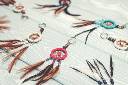 Ethnic dreamcatchers on a wooden background. Dream catchers, indian amulet, feathers, decoration.