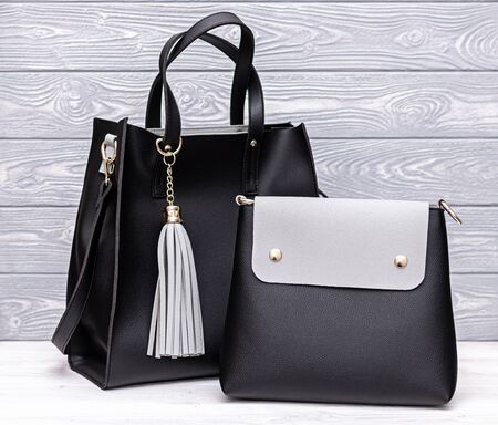 Fashion synthetic leather black handbag on a wooden background. Eco leather.の写真素材