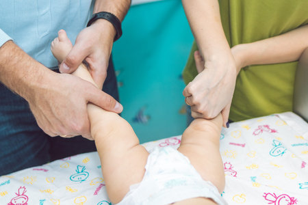 Baby massage. Parents are massaging the baby.