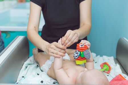Baby massage. Mother is massaging the baby. Health massage.の写真素材