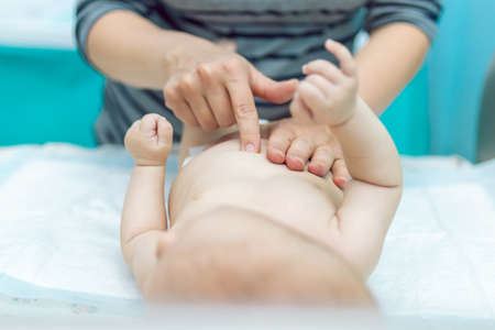 Baby massage closeup. Mother and child. Newborn.の写真素材