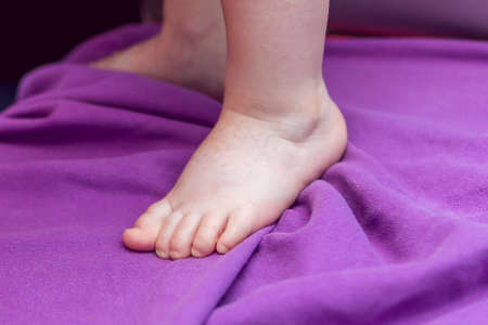 Newborn baby leg closeup. Small fingers.の写真素材