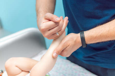 Baby massage closeup. Father and child. Newborn.の写真素材