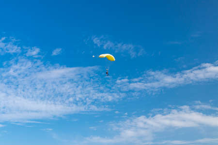 Parachutist is flying in the sky, sunny contrast image.の写真素材