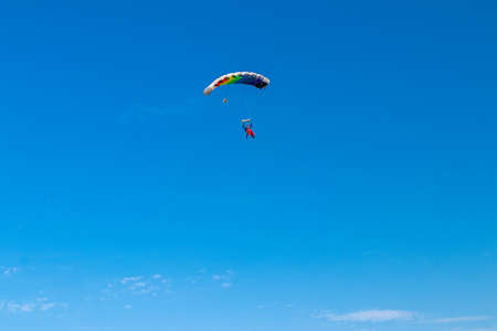 Parachutist is flying in the sky, sunny contrast image.の写真素材