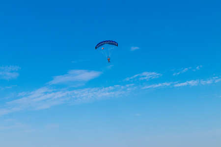 Parachutist is flying in the sky, sunny contrast image.の写真素材