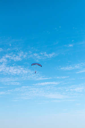 Parachutist is flying in the sky, sunny contrast image.の写真素材