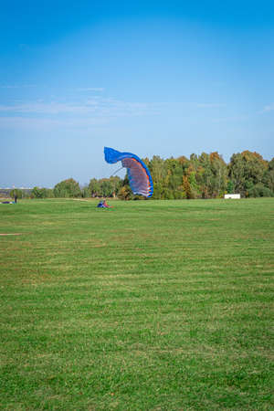 Rarachutist lands on the ground.の写真素材