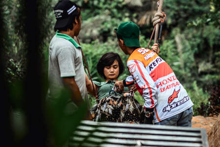 BALI, INDONESIA - MAY 16, 2018: Young woman swings in the jungle of Bali island. Rainforest of Indonesia. Travel concept.のeditorial素材