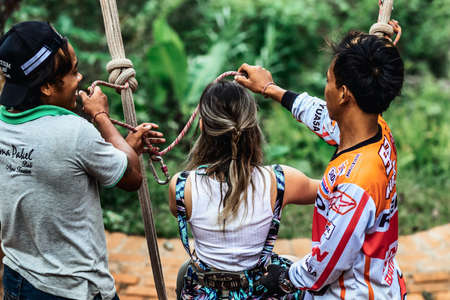 BALI, INDONESIA - MAY 16, 2018: Young woman swings in the jungle of Bali island. Rainforest of Indonesia. Travel concept.のeditorial素材