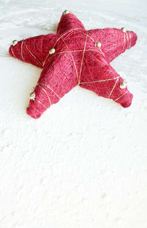 red Christmas star with golden balls on a white backgroundの写真素材