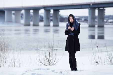 The girl at the bridge in the winter outside,の写真素材