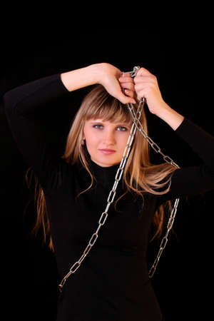 Beautiful girl with chain in handsの写真素材