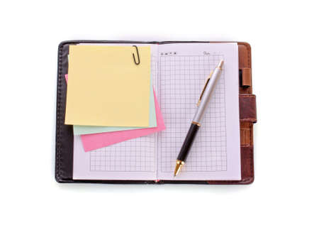 Open notebook with a pen on whiteの写真素材