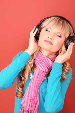 Beautiful young  women listening music in headphonesの写真素材