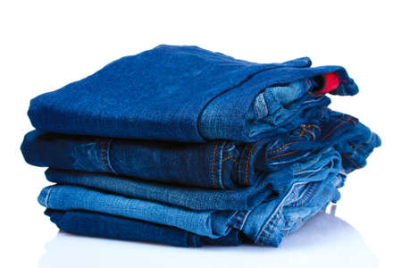lot of blue jeans isolated on whiteの写真素材