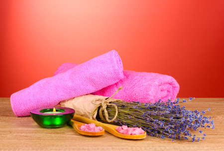 Beautiful lavender, salt and towels on a red backgroundの写真素材