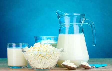 Dairy products on wooden table on blue backgroundの写真素材