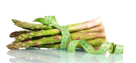 delicious asparagus and measuring tape isolated on whiteの写真素材