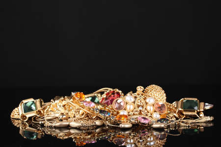 Various gold jewellery on black backgroundの写真素材