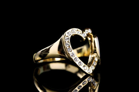 beautiful gold ring with precious stones on black backgroundの写真素材