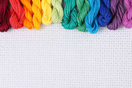 sewing threads for embroidery on white cottonの写真素材