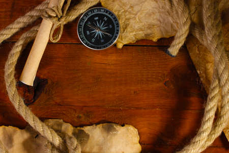 old paper, compass and rope on a wooden tableの写真素材