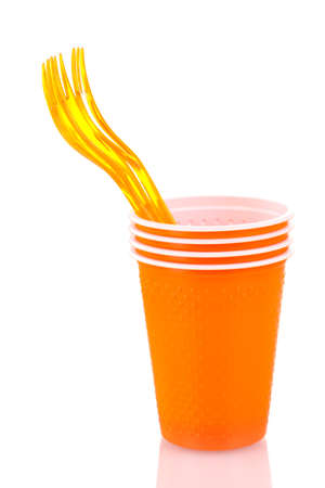 Bright orange plastic cups and forks isolated on whiteの写真素材