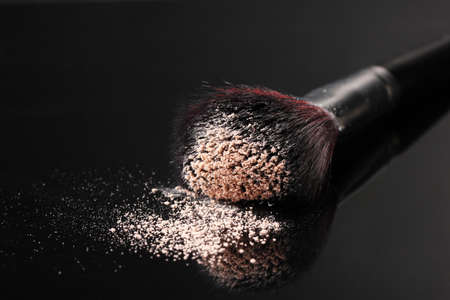 Make up brush with powder isolated on blackの写真素材