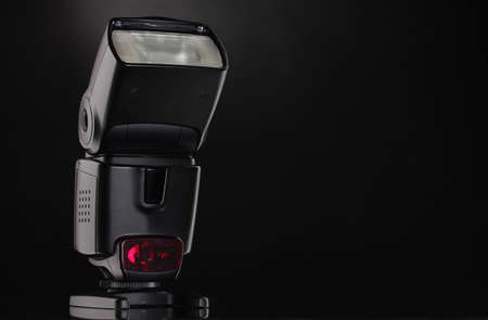 Photo camera flash on black backgroundの写真素材