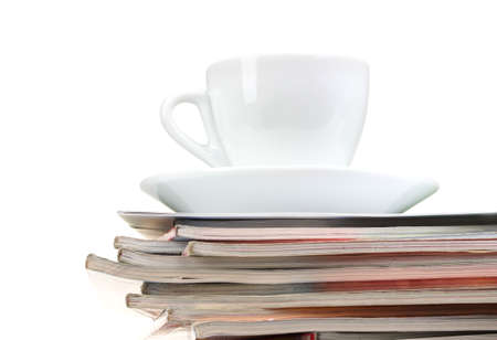 stack of magazines and cup isolated on whiteの写真素材