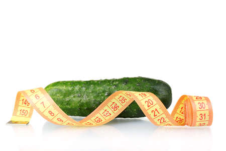 Cucumber with measuring tape isolated on whiteの写真素材