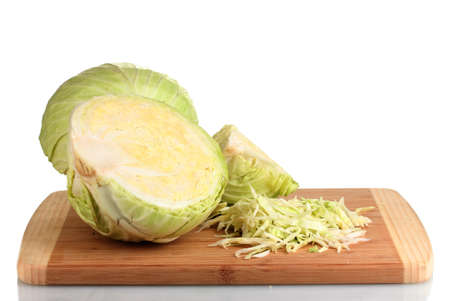 green cabbage shredded on wooden board isolated on whiteの写真素材