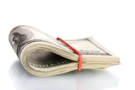 A lot of one hundred dollar bills tied rubber band isolated on whiteの写真素材