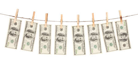 Alot of one hundred dollar bills is hanging on a rope with wooden clothespin isolated on whiteの写真素材