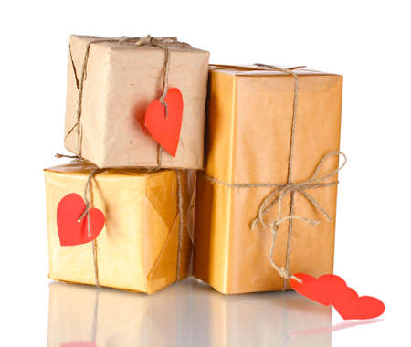 Three parcels with blank heart-shaped labels isolated on whiteの写真素材