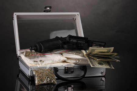 Cocaine and marijuana with gun in a suitcase on grey backgroundの写真素材