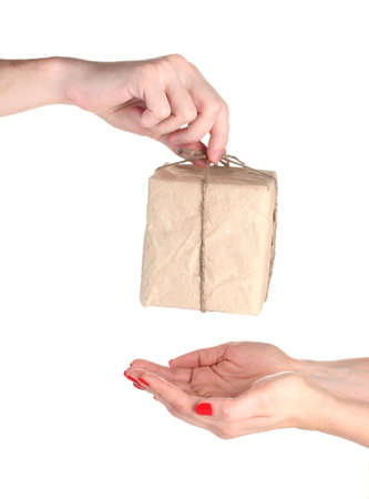 Man's hand giving parcel with blank heart-shaped label to woman isolated on whiteの写真素材