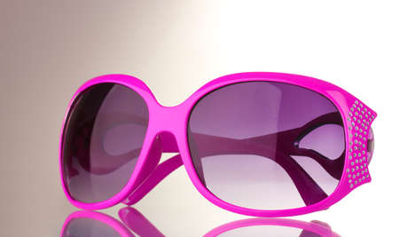 Women's pink sunglasses with diamonds isolated on whiteの写真素材