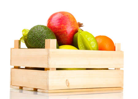 Assortment of exotic fruits in wooden box isolated on whiteの写真素材