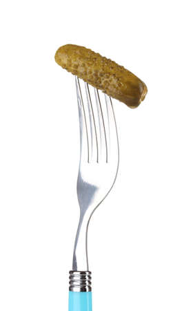 Marinated cucumber on fork isolated on whiteの写真素材