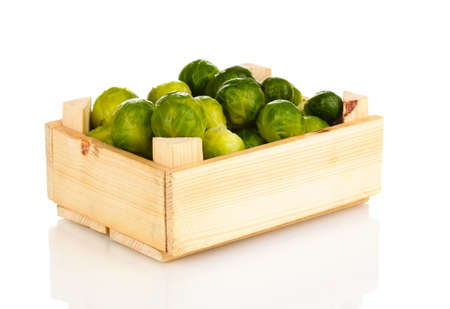 Brussels sprouts in wooden crate isolated on whiteの写真素材